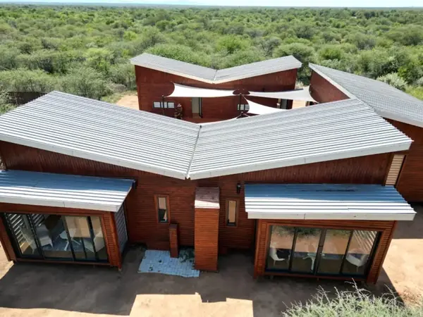Large timber home with angled roof sections, seen from above