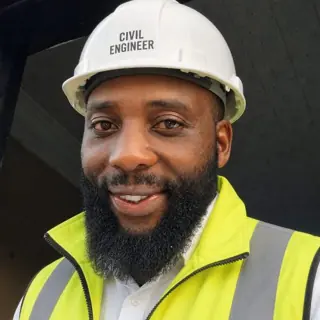 Life Temba Ngwenya wearing a hard hat and safety vest