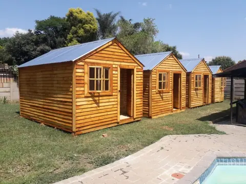 Row of new pine wendy houses with windows and doors