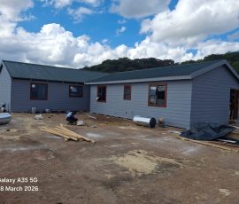 Large custom-built Nutec home with modern exterior by Mutsamvi Construction.