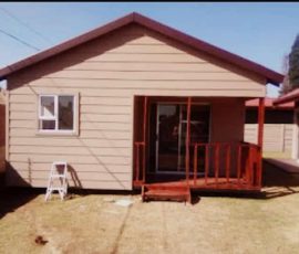 Custom-built Nutec home with covered patio and timber deck by Mutsamvi Construction.