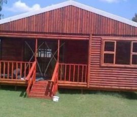 Traditional wooden log home with covered porch built by Mutsamvi Construction.